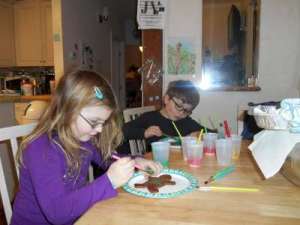 Painting Icing on Gingerbread People.